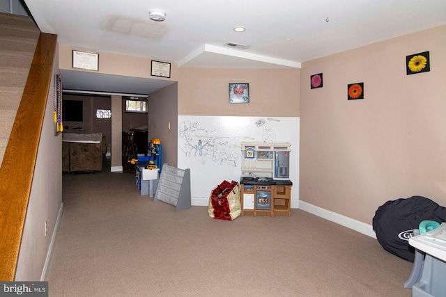 rec room featuring visible vents, carpet, and baseboards