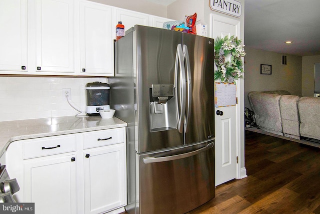 kitchen featuring decorative backsplash, stainless steel fridge with ice dispenser, white cabinets, open floor plan, and dark wood-type flooring