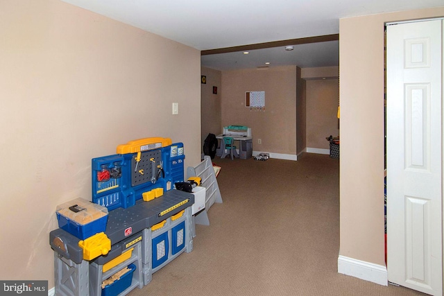 recreation room with carpet floors and baseboards