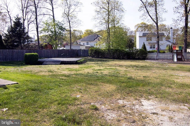 view of yard with a fenced backyard and a wooden deck