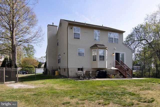 back of house featuring a lawn, fence, a chimney, and cooling unit