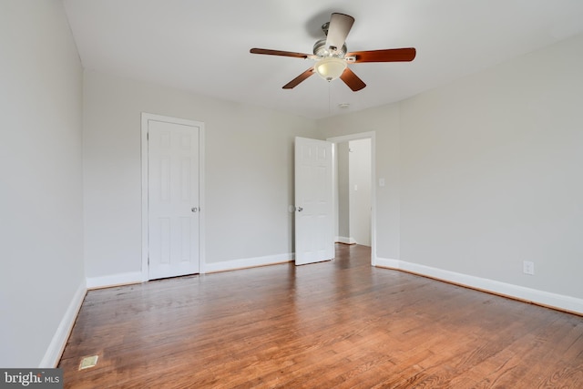 unfurnished bedroom featuring wood finished floors, baseboards, and ceiling fan