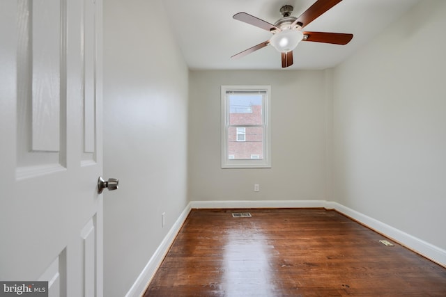 unfurnished room with wood finished floors, ceiling fan, and baseboards