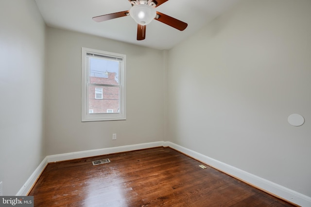 empty room with baseboards, wood finished floors, and ceiling fan