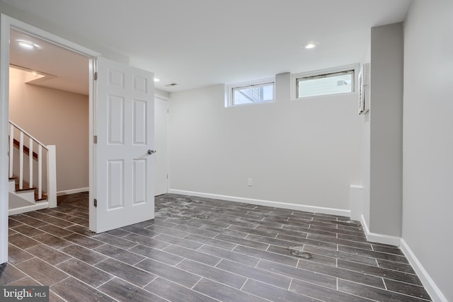basement featuring wood finished floors, baseboards, stairway, and recessed lighting