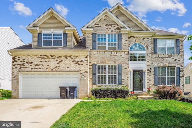 view of front of house featuring concrete driveway, brick siding, and a front yard
