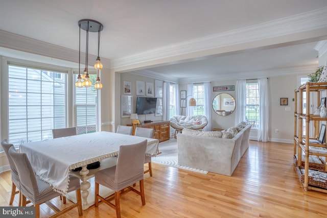 dining space with baseboards, ornamental molding, and light wood-type flooring