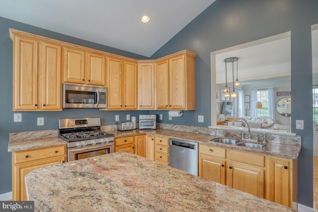 kitchen with stainless steel appliances, vaulted ceiling, light brown cabinets, a sink, and light stone countertops