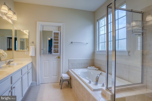 full bath with a bath, a sink, double vanity, a stall shower, and tile patterned flooring