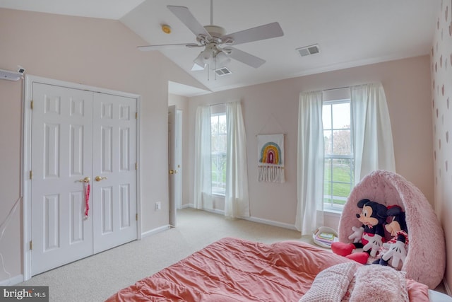 carpeted bedroom with vaulted ceiling, visible vents, a ceiling fan, a closet, and baseboards