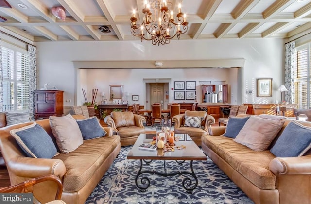 living room with coffered ceiling, beam ceiling, and an inviting chandelier