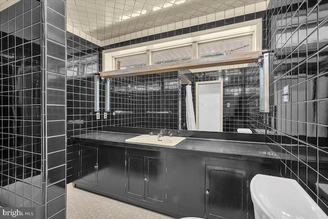 bathroom featuring vanity, tile walls, toilet, tile patterned flooring, and a shower with shower curtain