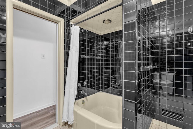 full bath with baseboards, wood finished floors, and shower / tub combo with curtain