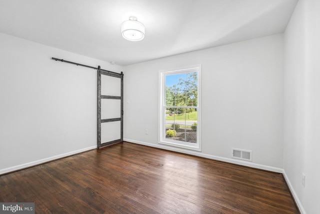 1399 Kimblewick Rd, Potomac, MD 20854 - unfurnished room featuring a barn door, wood finished floors, and baseboards