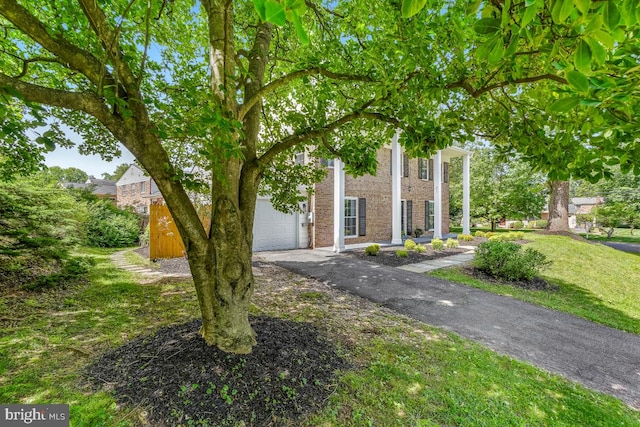 1399 Kimblewick Rd, Potomac, MD 20854 - view of front of home with a garage, asphalt driveway, and brick siding