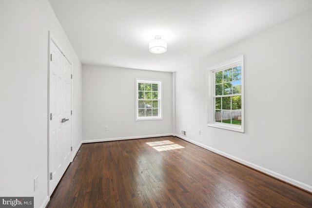 1399 Kimblewick Rd, Potomac, MD 20854 - unfurnished bedroom featuring multiple windows, wood finished floors, and baseboards