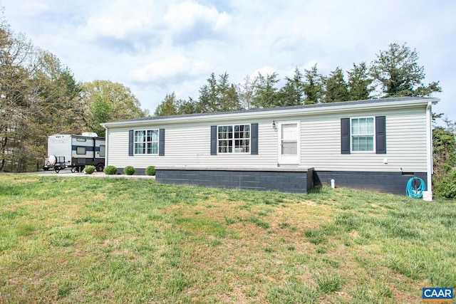 manufactured / mobile home with crawl space and a front lawn