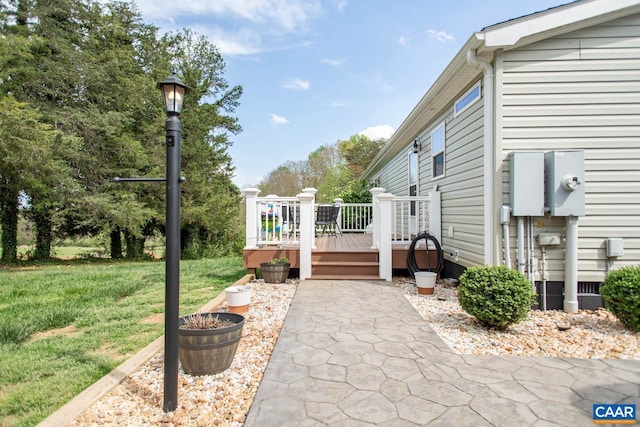 view of home's exterior with a yard and a deck