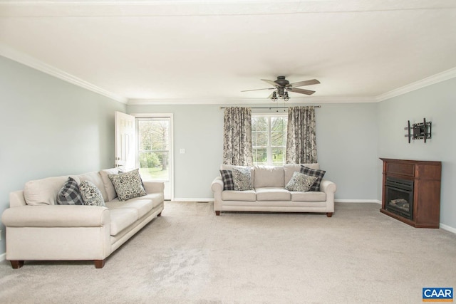 living room featuring ornamental molding, a wealth of natural light, and light colored carpet