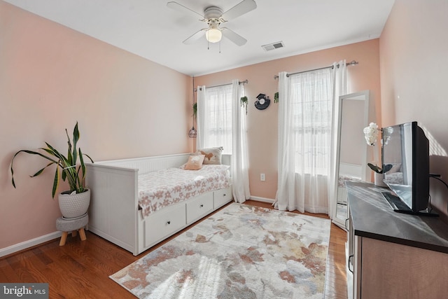 bedroom with visible vents, ceiling fan, baseboards, and light wood-style floors