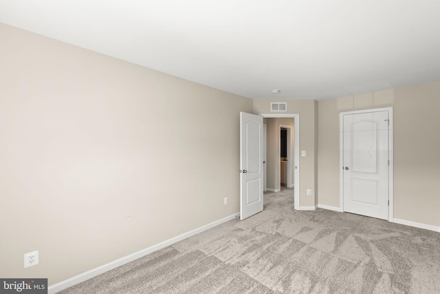 unfurnished bedroom with visible vents, baseboards, and carpet flooring