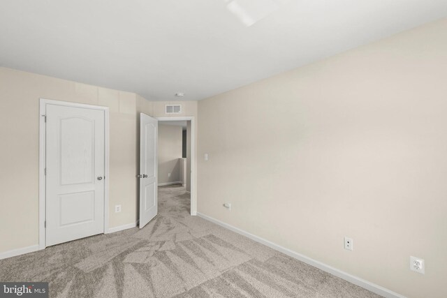 unfurnished bedroom with baseboards, visible vents, and carpet floors