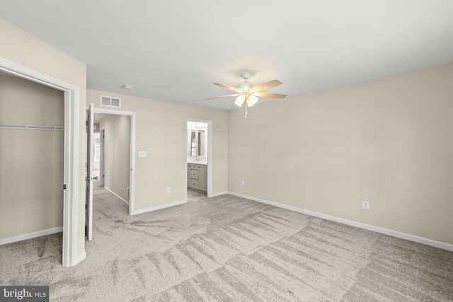 unfurnished bedroom featuring visible vents, a closet, baseboards, light colored carpet, and ceiling fan