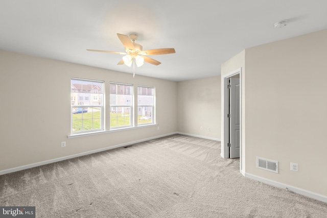 unfurnished bedroom with baseboards, visible vents, carpet, and ceiling fan