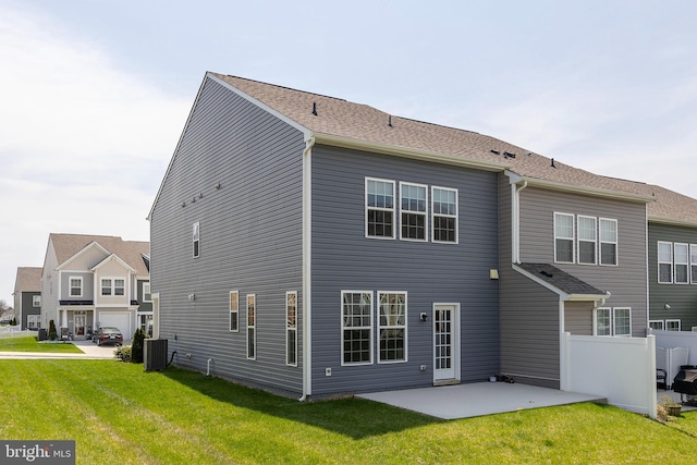 back of property featuring fence, a yard, cooling unit, and a patio