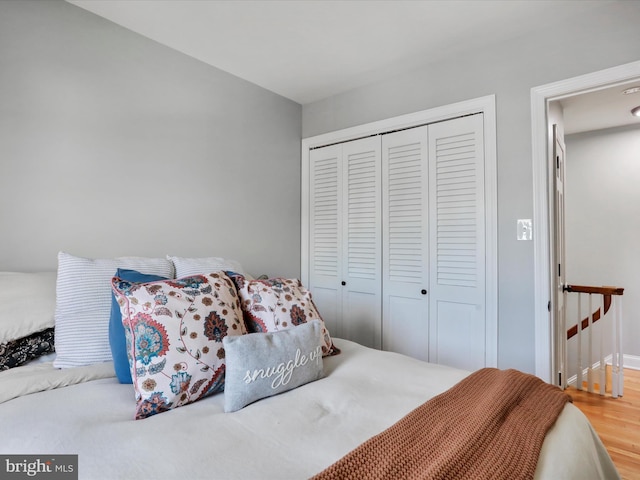 bedroom featuring wood finished floors and a closet
