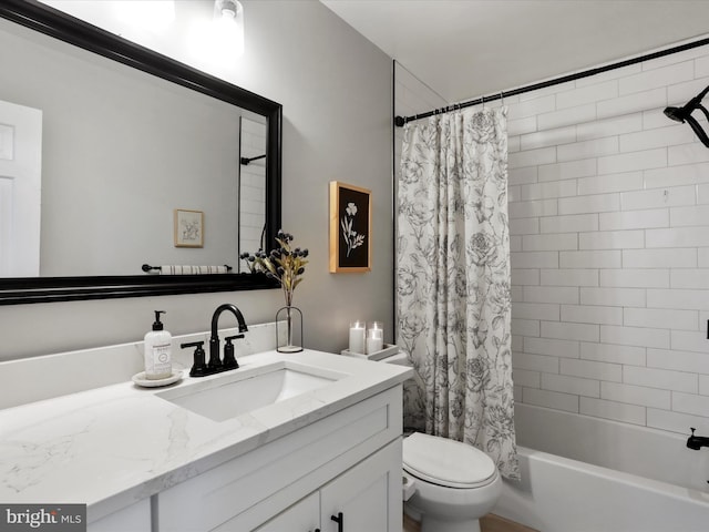 bathroom featuring shower / tub combo with curtain, toilet, and vanity
