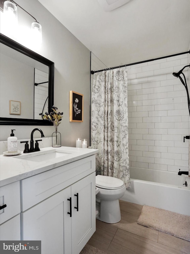 full bathroom with shower / tub combo, toilet, vanity, and wood finished floors
