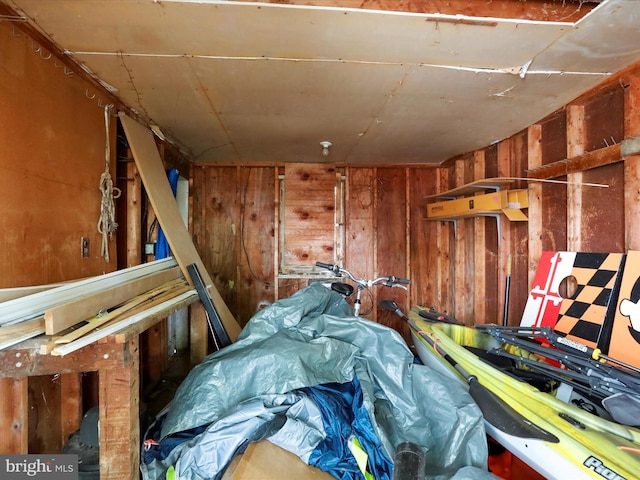 misc room featuring wood walls