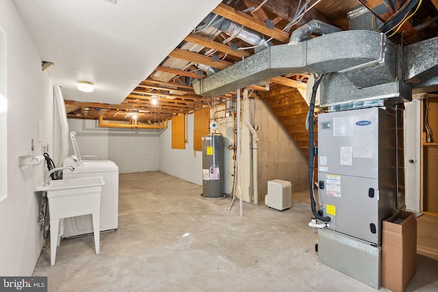 unfinished basement with independent washer and dryer, heating unit, and water heater