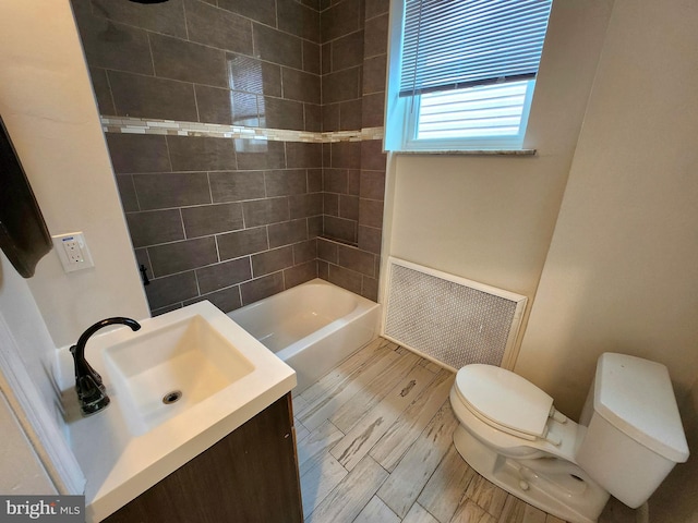 full bath with toilet, vanity, shower / bath combination, and visible vents