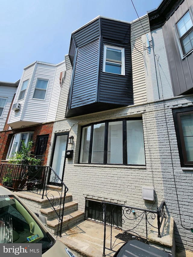 townhome / multi-family property featuring brick siding