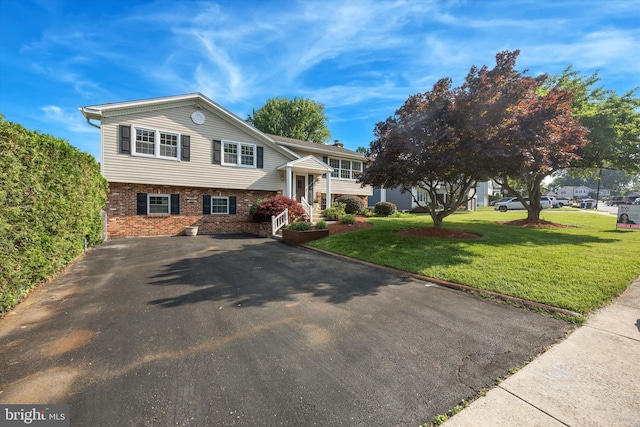 5 Morgan Rd, Aston, PA 19014 - split foyer home with brick siding, a front yard, and driveway