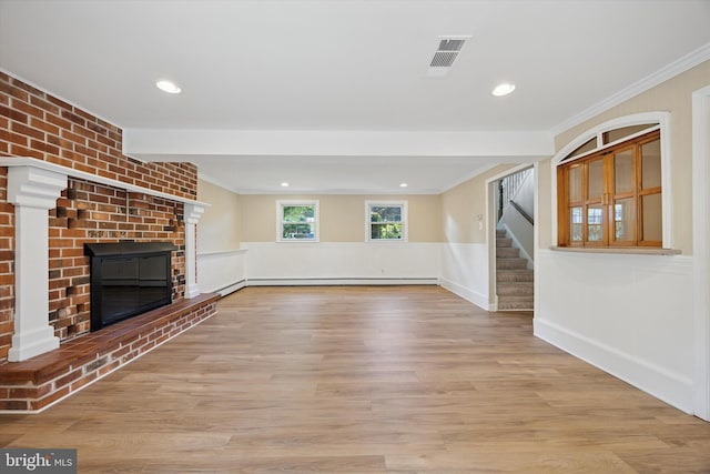 5 Morgan Rd, Aston, PA 19014 - unfurnished living room with a fireplace, ornamental molding, stairs, a baseboard radiator, and wood finished floors