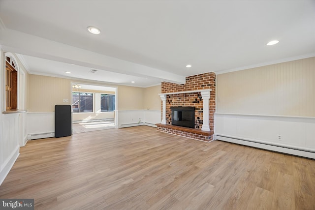 5 Morgan Rd, Aston, PA 19014 - unfurnished living room featuring a baseboard heating unit, a decorative wall, ornamental molding, light wood finished floors, and a brick fireplace