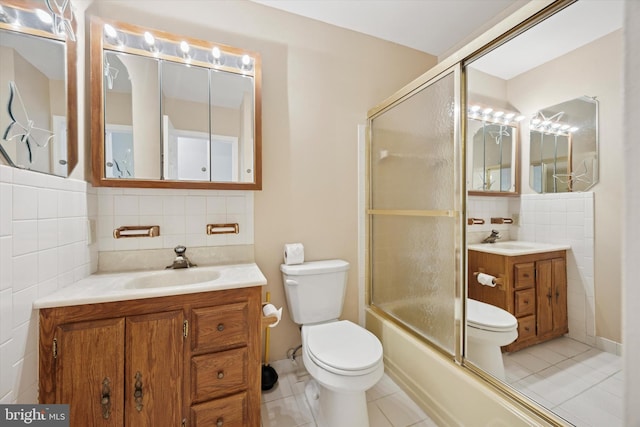 5 Morgan Rd, Aston, PA 19014 - bathroom with tile patterned flooring, vanity, tile walls, shower / bath combination with glass door, and decorative backsplash