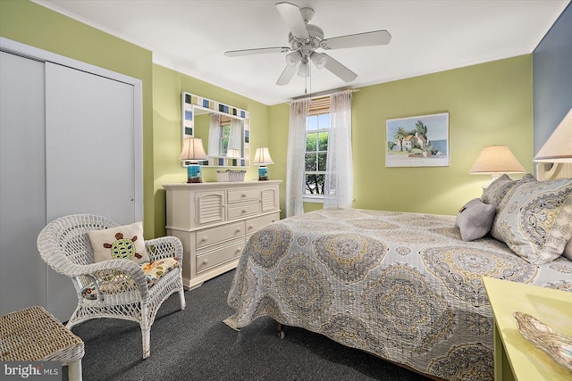 bedroom featuring crown molding, a ceiling fan, and dark carpet