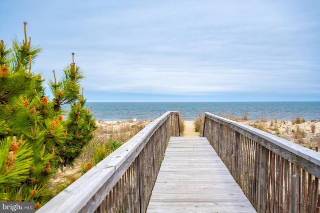 surrounding community featuring a water view and a view of the beach