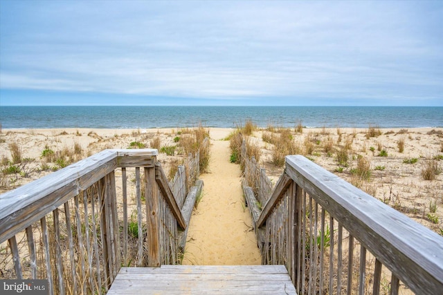 exterior space with a water view and a view of the beach