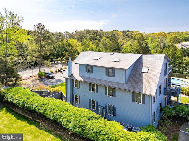 exterior space featuring a wooded view