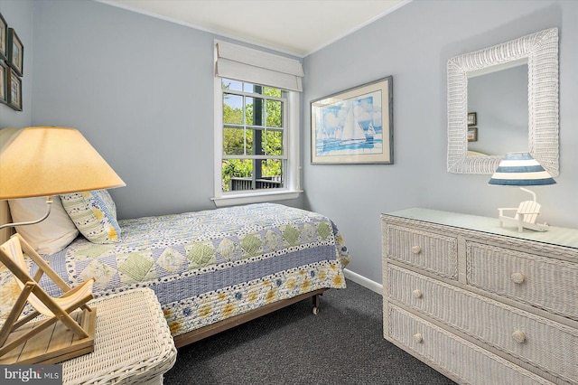 bedroom with crown molding, carpet flooring, and baseboards