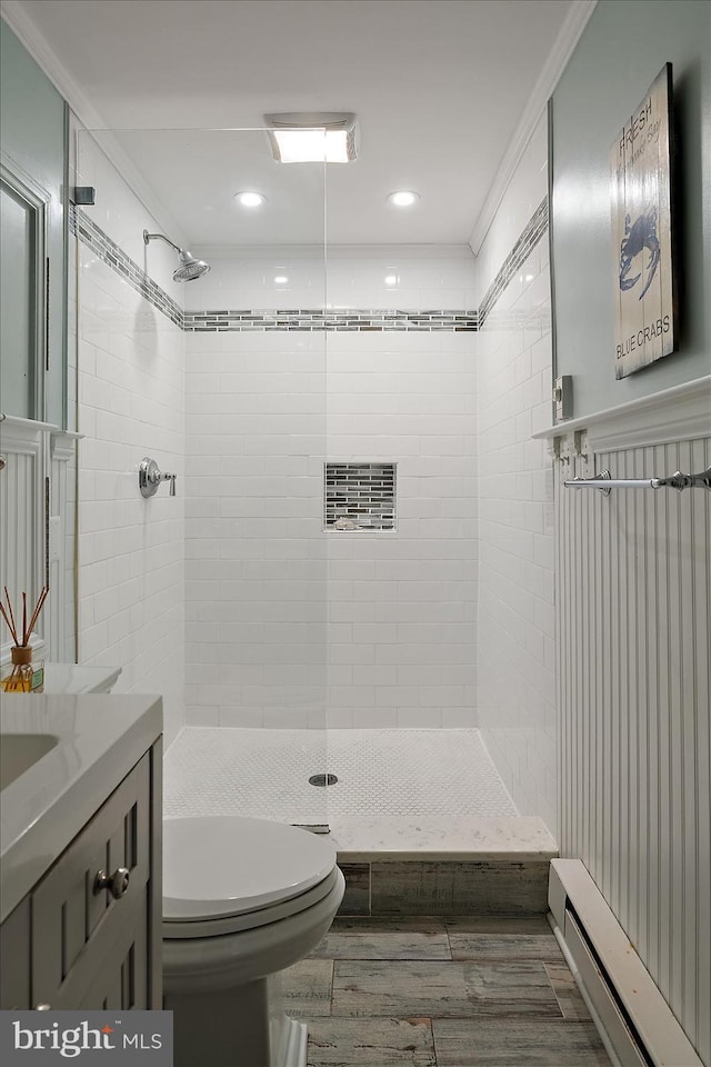 bathroom featuring baseboard heating, toilet, recessed lighting, a shower stall, and wood finished floors