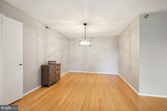 15100 Interlachen Dr Unit 4-522, Silver Spring, MD 20906 - spare room with light wood finished floors and a chandelier
