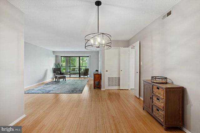15100 Interlachen Dr Unit 4-522, Silver Spring, MD 20906 - unfurnished dining area with light wood-style floors and a chandelier