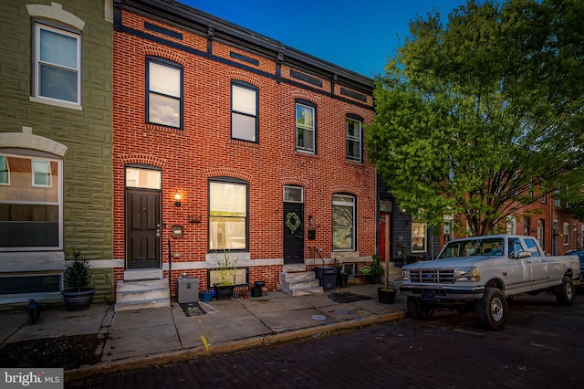 view of property with brick siding and entry steps