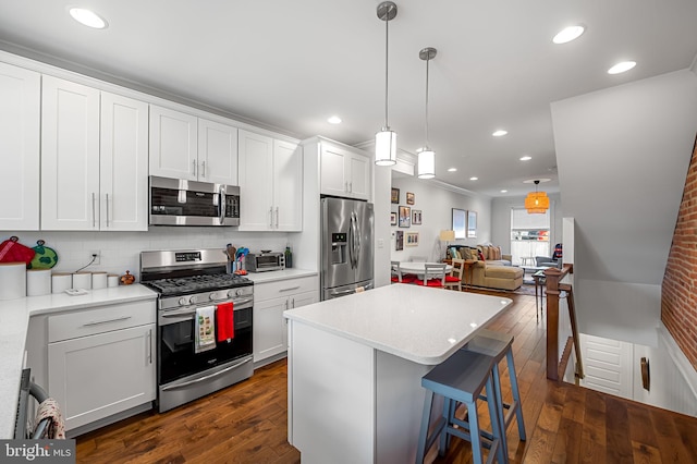 kitchen featuring dark wood-style floors, stainless steel appliances, a center island, tasteful backsplash, and open floor plan